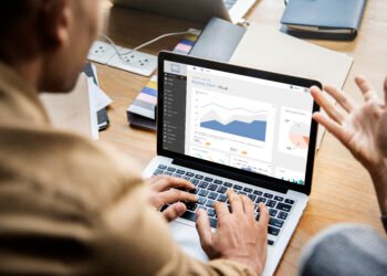 People working on a laptop in a meeting